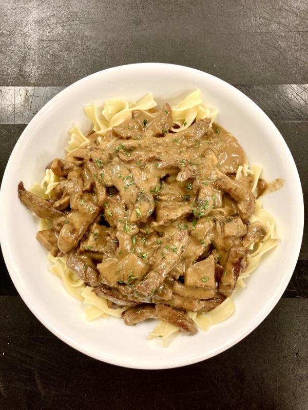 Beef stroganoff over noodles